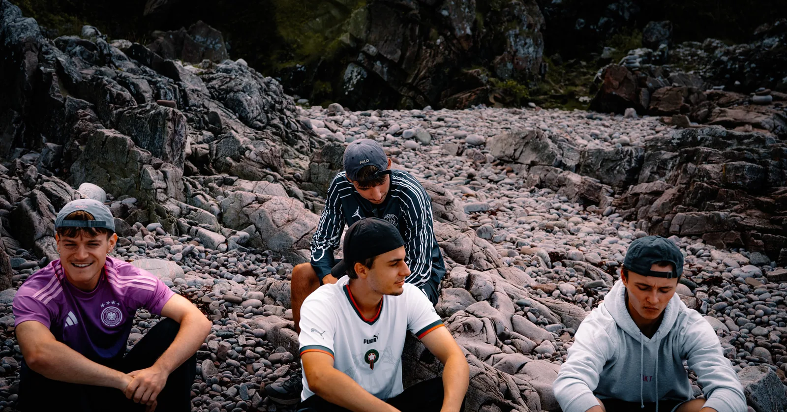 Group of friends resting together on smooth pale rocks in Sweden